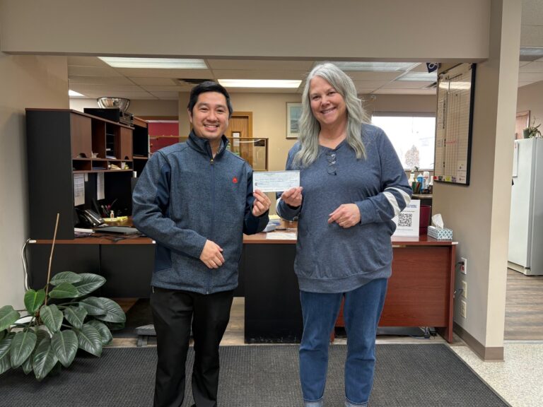 Photo of McDonald's Manager presenting a cheque to CFEC